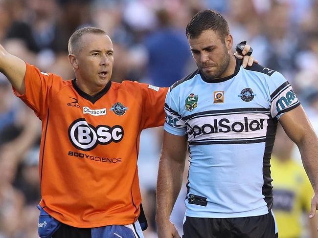 SYDNEY, AUSTRALIA - MARCH 19: Wade Graham of the Sharks leaves the field with a trainer during the round three NRL match between the Cronulla Sharks and the St George Illawarra Dragons at Southern Cross Group Stadium on March 19, 2017 in Sydney, Australia. (Photo by Mark Kolbe/Getty Images)