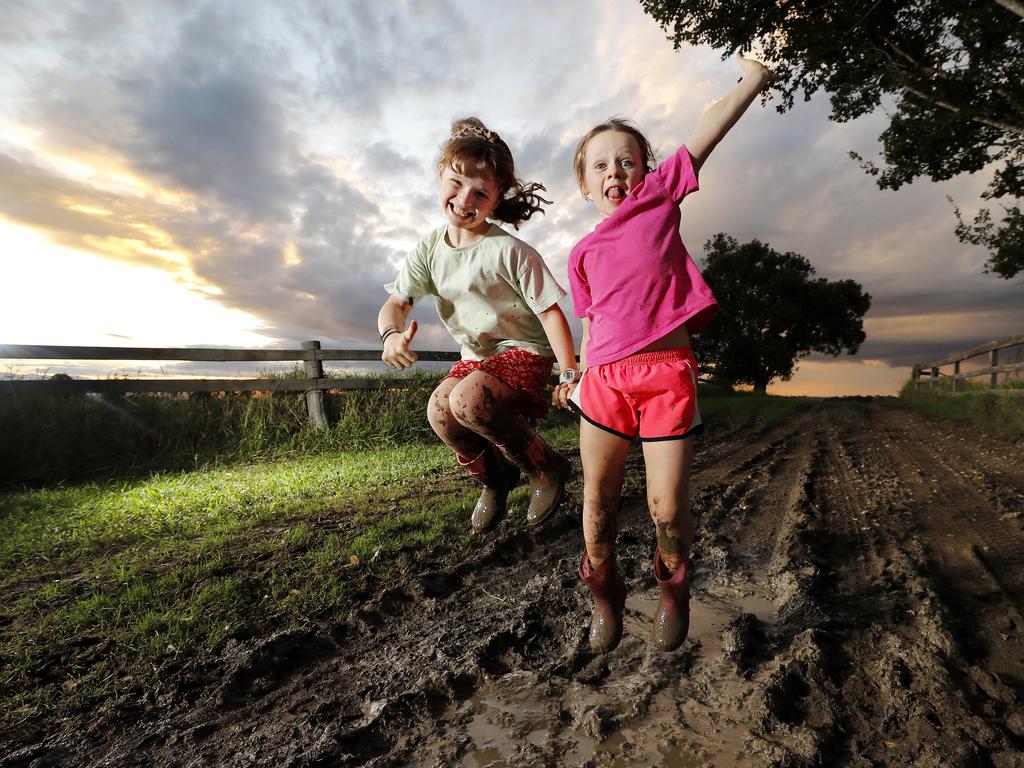 Georgie Lochran, 8, and Amelia Lochran, 6, on their property in Kulgun. The region has already exceeded its annual rainfall total. Picture: Josh Woning