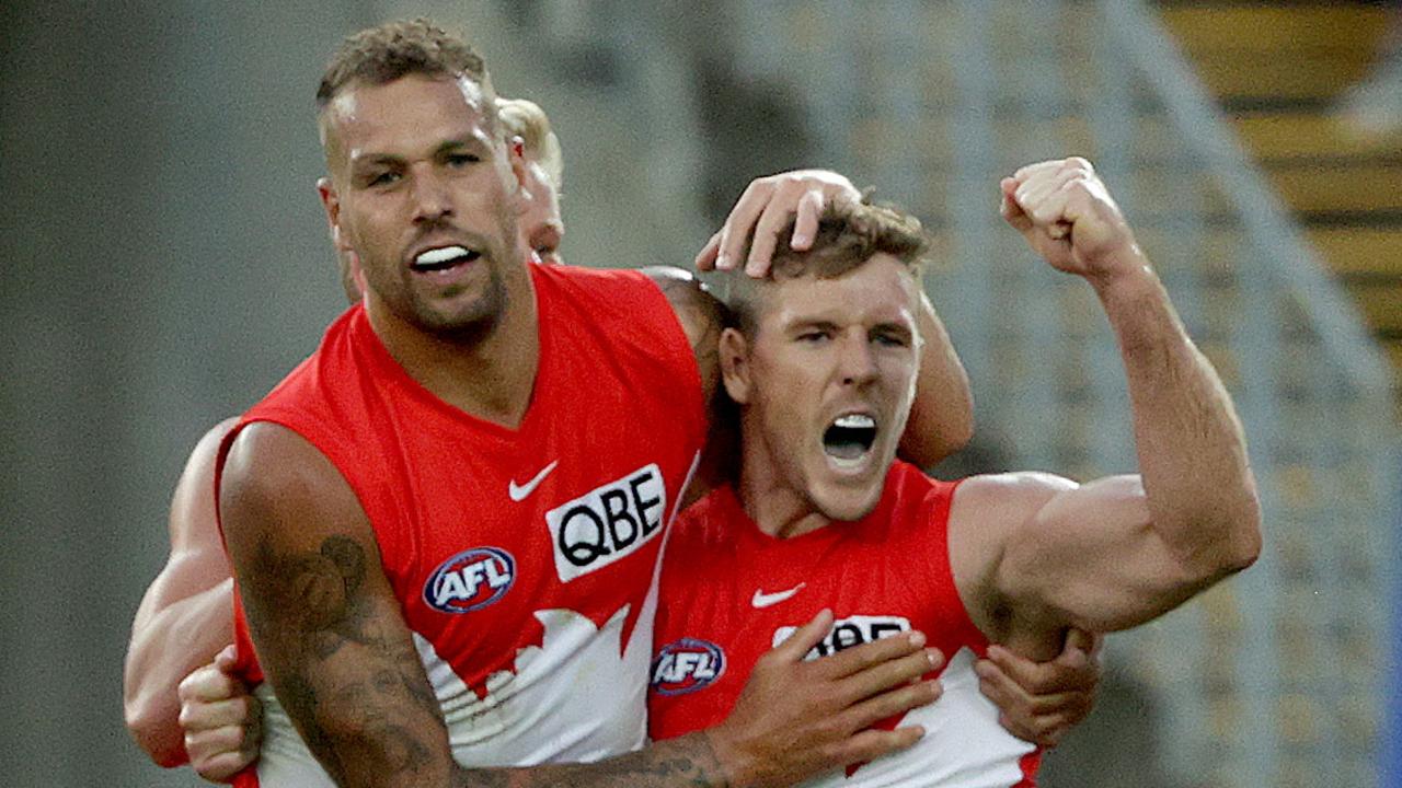 Lance Franklin celebrates a goal with Sydney matchwinner Luke Parker.