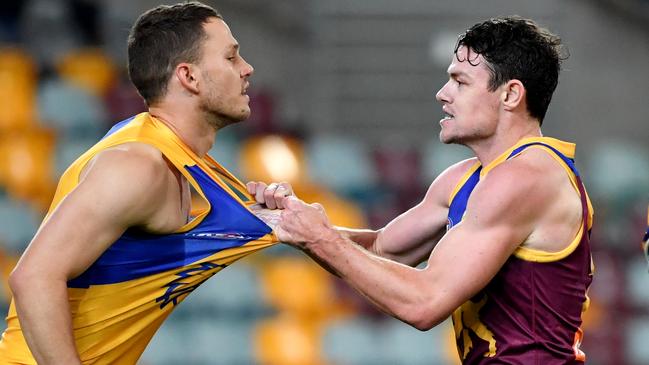 Jack Redden (left) of the Eagles is grabbed by Lachie Neale (right) of the Lions during the Round 3 AFL match between the Brisbane Lions and the West Coast Eagles at The Gabba in Brisbane, Saturday, June 20, 2020. (AAP Image/Darren England) NO ARCHIVING, EDITORIAL USE ONLY