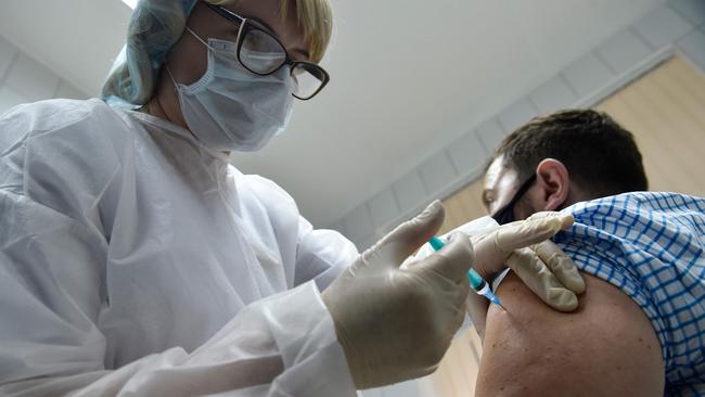 A nurse inoculates volunteer Ilya Dubrovin, 36, with Russia's new coronavirus vaccine, Sputnik V, in September. Picture: AFP