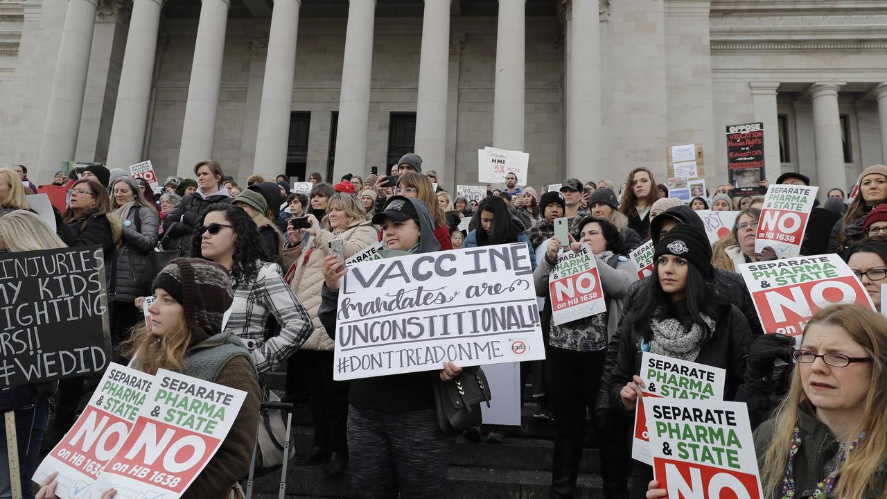 Anti-vaxxers hold signs at a protest this month in Washington.