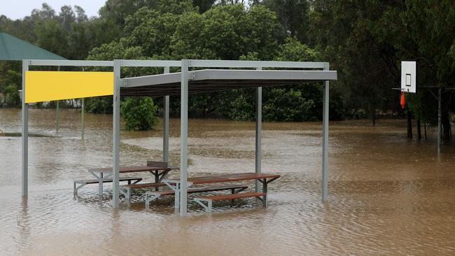 Lakewoods reserve on 19th Avenue Elanora turns into a giant lake flooding the BBQ area and basketball court after torrential rain over night causing the creek to break its banks. NCA NewsWire / Scott Powick