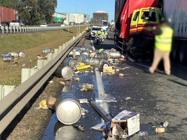 There are major delays across Brisbane this morning with a spate of crashes causing traffic chaos for commuters with a mass beer keg spill blocking lanes of a major motorway and a multi-truck smash closing the Bruce Highway. Picture: QLD Police