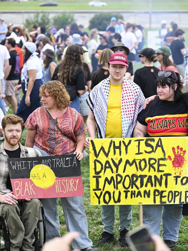 People held up signs that said ‘White Australia has a blak history’ in Canberra. Picture: NewsWire / Martin Ollman