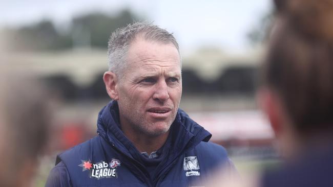 MELBOURNE, AUSTRALIA - APRIL 02: Paul Corrigan, head coach of the Falcons talks to his players during the NAB League Girls Semi Final match between Dandenong and Geelong at Skybus Stadium on April 02, 2022 in Melbourne, Australia. (Photo by Mike Owen/AFL Photos/Getty Images)