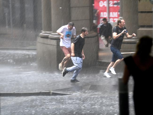 Sydneysiders are drenched in the rain during the storm. Picture: NCA NewsWire / Jeremy Piper