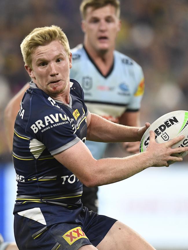 Tom Dearden of the Cowboys runs the ball during the round 15 NRL match between the North Queensland Cowboys and the Cronulla Sharks. (Photo by Ian Hitchcock/Getty Images)