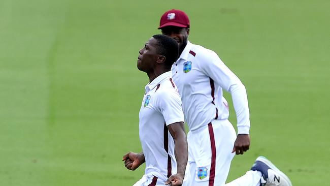 Shamar Joseph of the West Indies celebrates after taking the wicket of Pat Cummins. Picture: Bradley Kanaris/Getty Images.