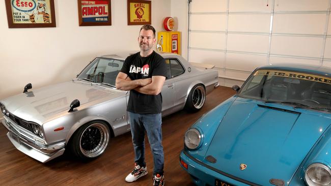 Car enthusiast Adam Cannell with two of his modified cars – his current garage is an enthusiast’s paradise. Picture: Dean Martin