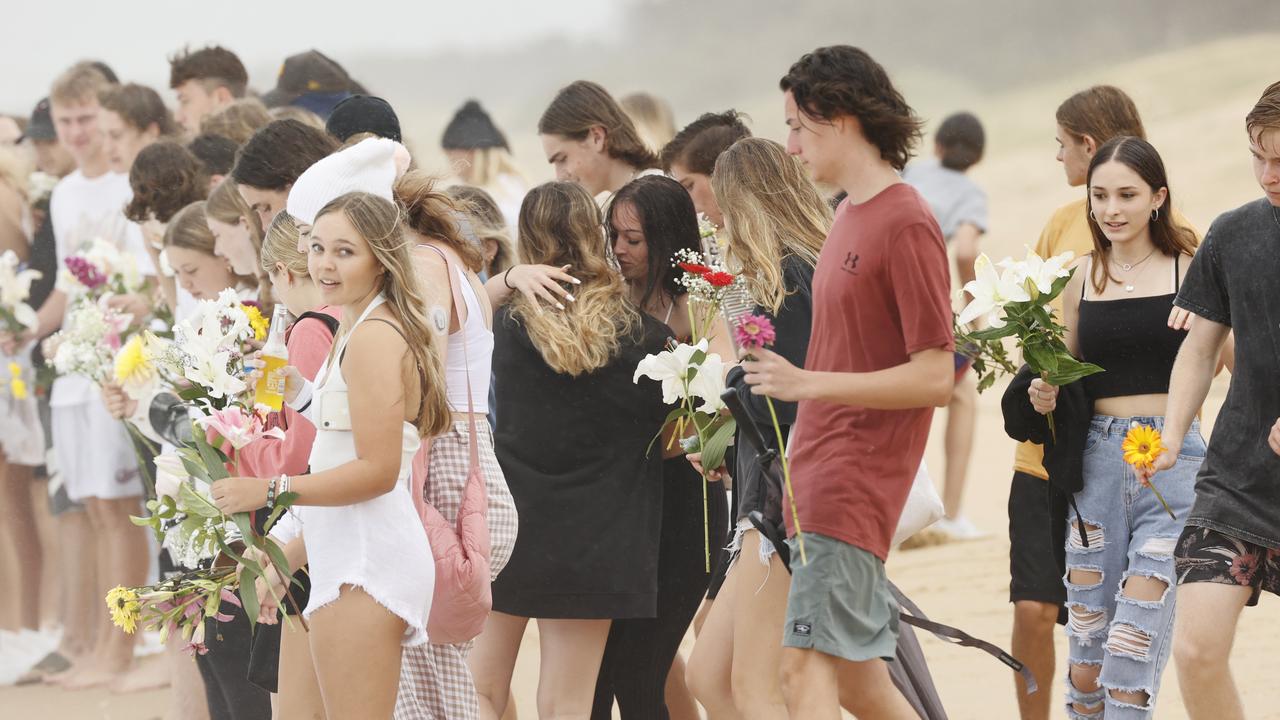 Family and friends of 16-year-old alleged stabbing victim Balin Stewart gather to pay tribute on his home beach at Buddina. Picture: Lachie Millard