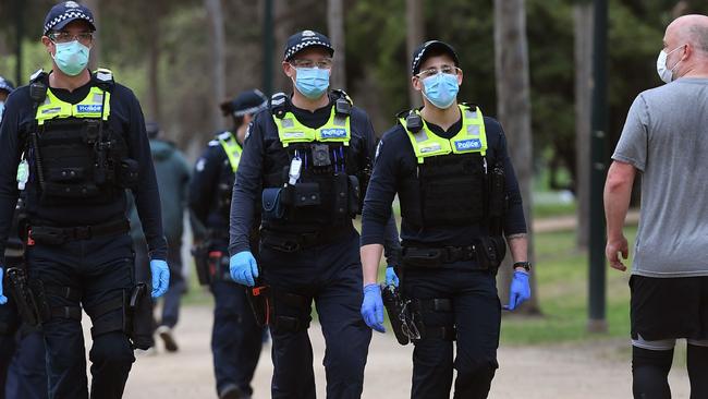 Police patrol the Tan Track in Melbourne. Picture: AFP