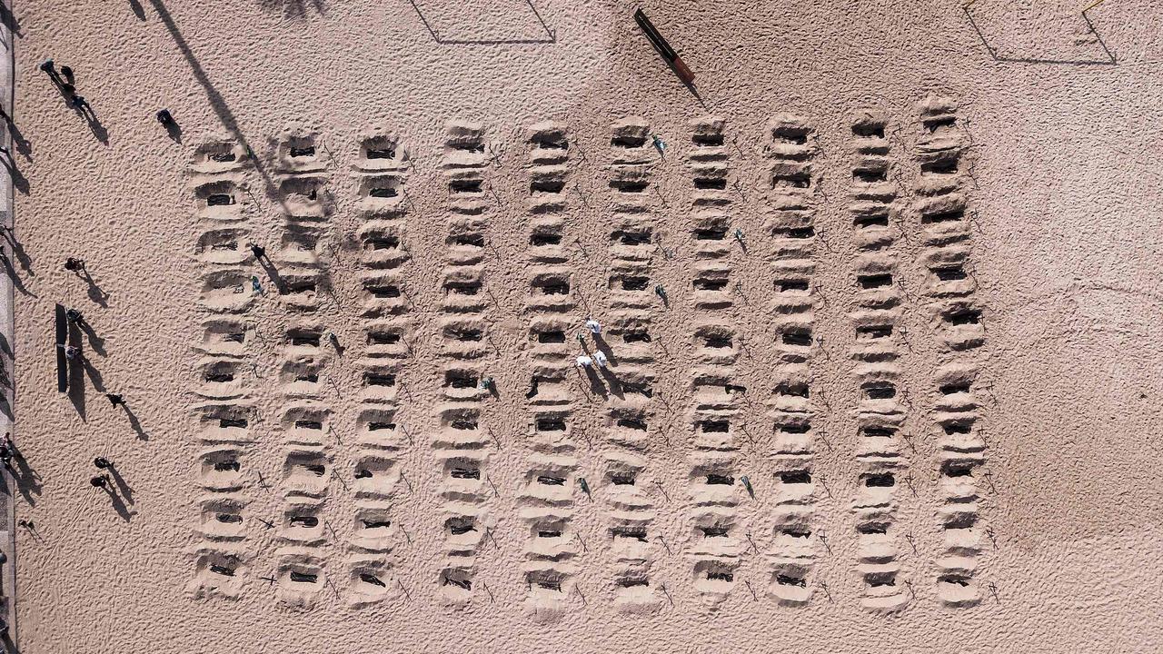 Aerial view of activists from the Brazilian NGO Rio de Paz digging mock graves on Copacabana beach. Picture: Florian Plaucheur/AFP