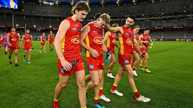 Nick Holman with Suns teammates. Picture: Daniel Carson/AFL Photos via Getty Images