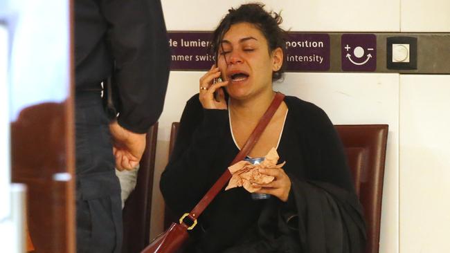 A relative of the victims of the EgyptAir flight 804 reacts as she makes a phone call at Charles de Gaulle Airport outside of Paris.