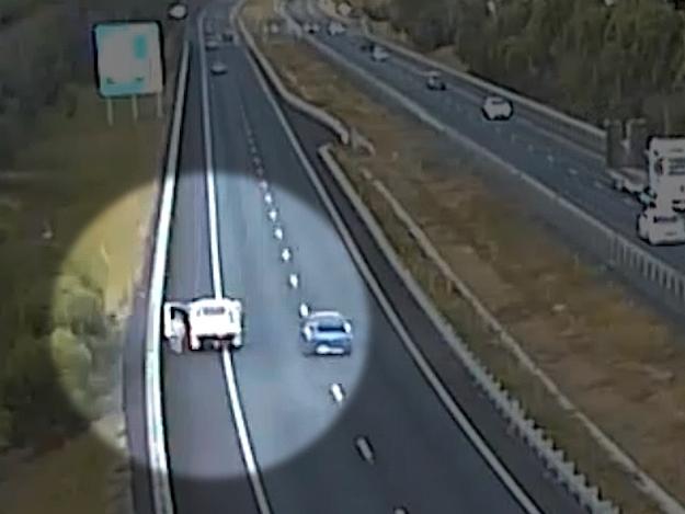 A parked vehicle protrudes on to a lane of a busy motorway. Picture: Transurban