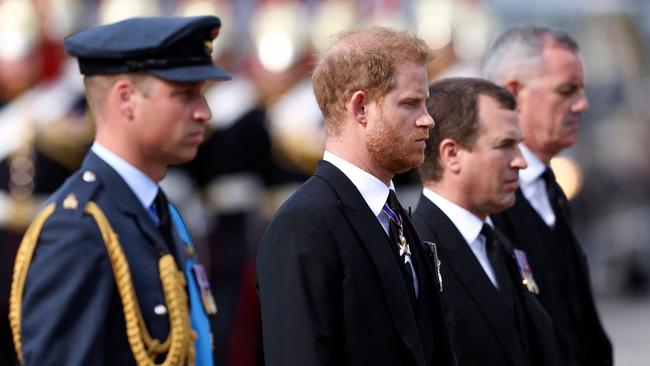 Prince William, Prince of Wales, Prince Harry, Duke of Sussex and Peter Phillips, walk behind the coffin of Queen Elizabeth II, during a procession from Buckingham Palace to the Palace of Westminster, in London. (Photo by Richard Heathcote / POOL / AFP)