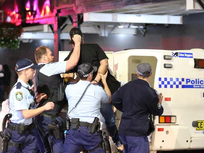 A man is arrested by police in Kings Cross after he was allegedly trying to start fights with strangers, before being detained by police. 