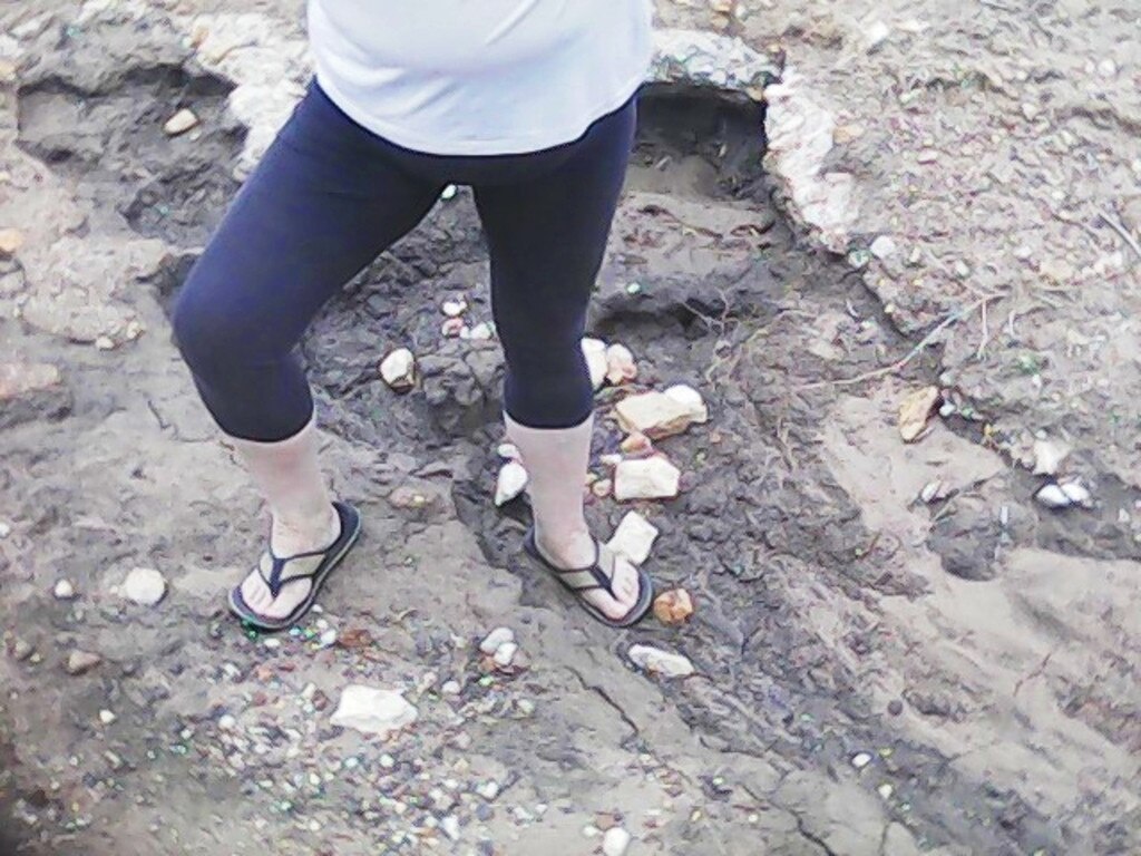 David Parry from Tara is concerned the state of the region's unsealed roads is going to end in tragedy. Mr Parry’s wife is photographed standing in one of the washouts along Gazzard’s Road earlier this year. Picture: Contributed