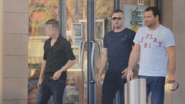 The courier (left), Ibrahim Yavuz (centre) and Alfred Kola (right) after leaving Flight Centre at Mawson Lakes in May 2014 after purchasing the courier flights to Panama. Picture: Courts SA.