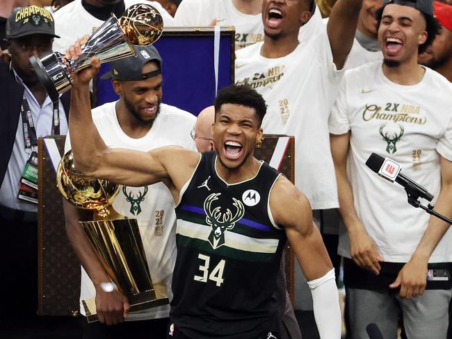 Giannis Antetokounmpo celebrates after receiving the Bill Russell trophy for Finals MVP. Photo: Jonathan Daniel/Getty Images/AFP