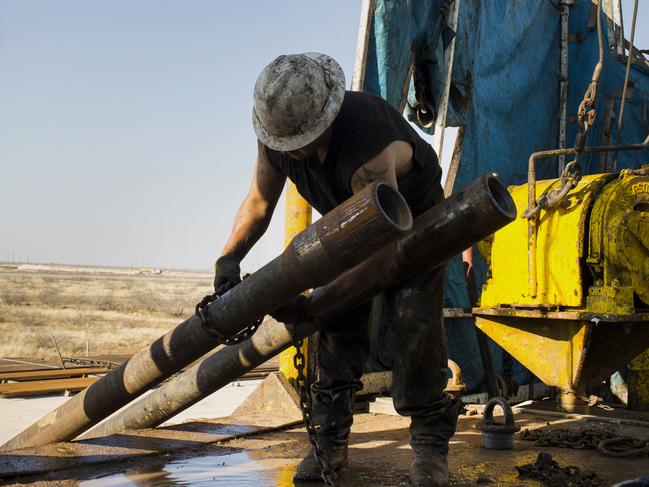 A worker prepares to lift drills by pulley to the main floor of Endeavor Energy Resources LP's Big Dog Drilling Rig 22 in the Permian basin outside of Midland, Texas, U.S., on Friday, Dec. 12, 2014. Of all the booming U.S. oil regions set soaring by a drilling renaissance in shale rock, the Permian and Bakken basins are among the most vulnerable to oil prices that settled at $57.81 a barrel Dec. 12. With enough crude by some counts to exceed the reserves of Saudi Arabia, theyâ€™re also the most critical to the future of the U.S. shale boom. Photographer: Brittany Sowacke/Bloomberg