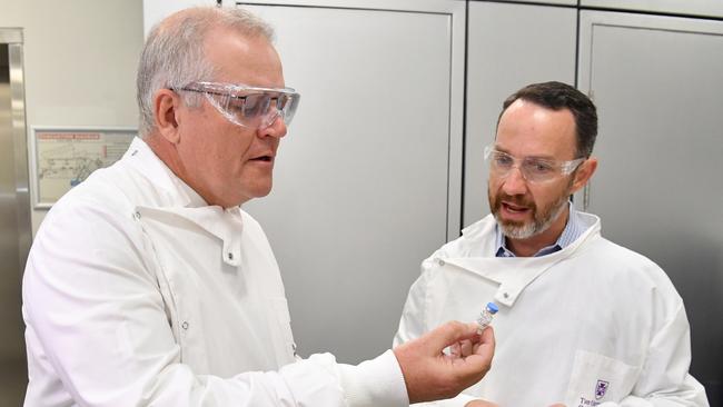 Scott Morrison looks at a vial of the COVID-19 vaccine candidate with Professor Trent Munro (right) during a tour of the University of Queensland Vaccine Lab in Brisbane. Picture: AAP Image/Darren England via NCA NewsWire