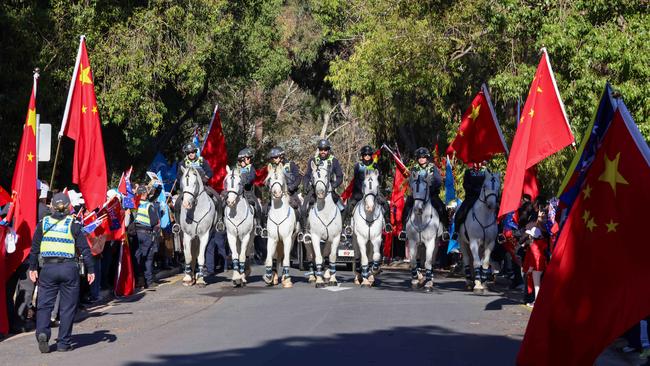 Police, including mounted patrols, kept a close eye on protesters at the zoo during Premier Li’s visit. Picture: Russell Millard