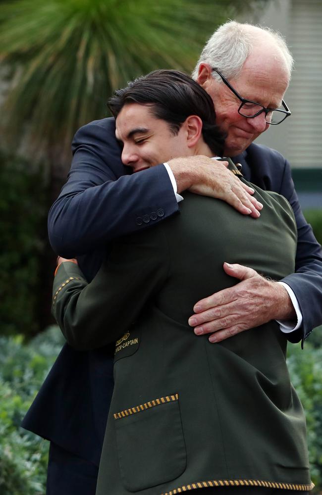 Rohan Brown greets students as they return on their first day of school from holidays. Picture: Aaron Francis/The Australian