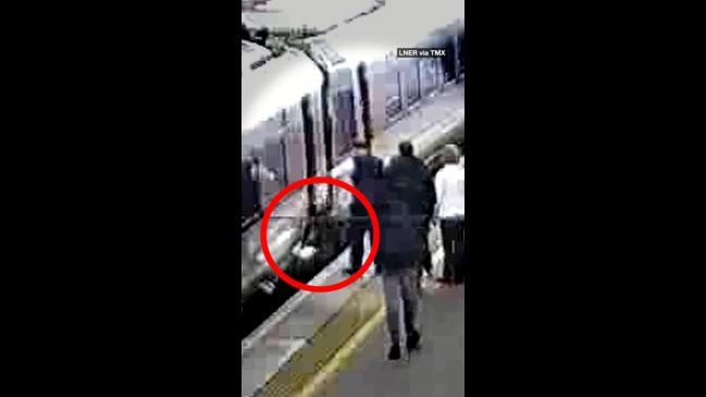 Terrifying moment child falls between train gap