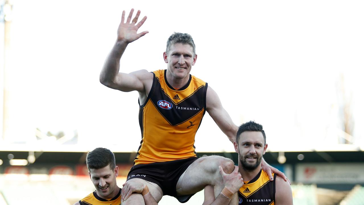 The retiring Ben McEvoy is chaired off by Luke Breust and Jack Gunston. Picture: Dylan Burns/AFL Photos via Getty Images