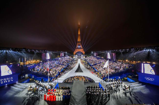 Overview of the Trocadero venue, with the Eiffel Tower looming in the background while the Olympic flag is being raised, during the opening ceremony of the Paris 2024 Olympic Games on July 26, 2024 (Photo by FranÃ§ois-Xavier MARIT / AFP)