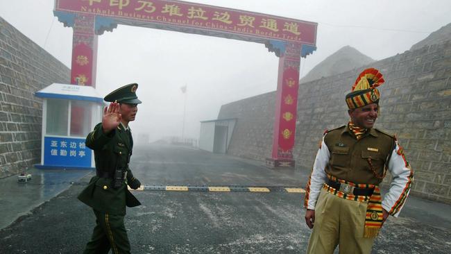 A Chinese and Indian soldier at the Nathu La border crossing between India and China in India's northeastern Sikkim state. Picture: AFP.