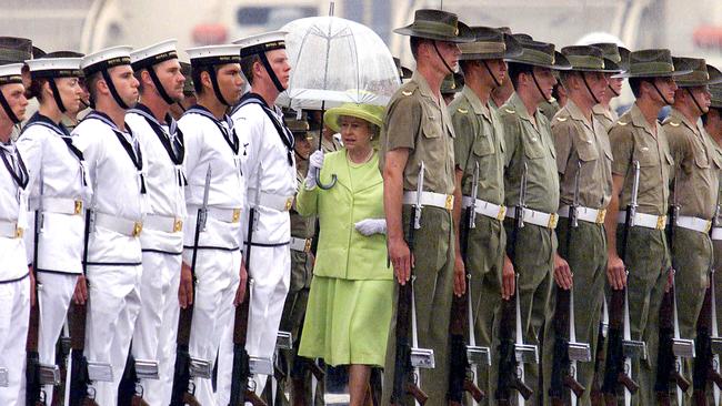 Queen Elizabeth inspects an honour guard consisting of Army, Navy and Air Force soldiers in the forecourt of Sydney Opera House in 2000.