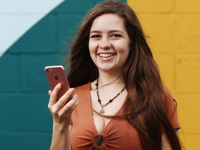 Australia's largest mobile phone network Telstra is changing its plans with an aim to attract new customers and to entice current customers to upgrade their phones. Kirra Watson, 19, of Kewarra Beach, is upgrading her current Telstra plan with a new one. PICTURE: BRENDAN RADKE