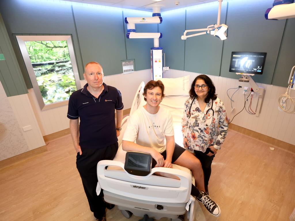 ICU of the future project manager Oystein Tronstad (left) with former patient Elliott Cox and The Prince Charles Hospital director of adult intensive care services Dr Jayshree Lavana in the redesigned ICU. Picture: Steve Pohlner