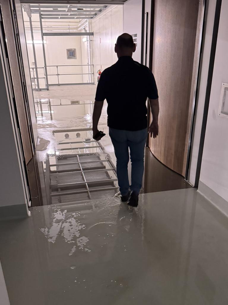 Workers clean up the flooding in the Bragg Centre. Picture: Chris Picton