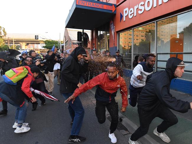 Protesters flee as police deploy pepper spray at the rally. Picture: AAP Image/James Ross