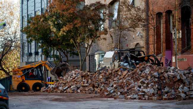 A bobcat on Monday clearing tonnes of bricks from the Surry Hills building which caught fire last week, ahead of demolition works. Picture: NCA NewsWire / Nikki Short
