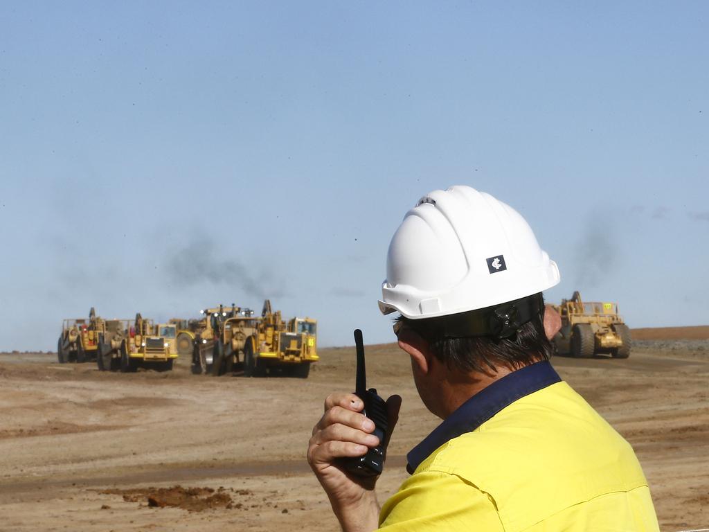An engineer watches as earthmovers carve out the runway at Western Sydney Airport. Picture: John Appleyard