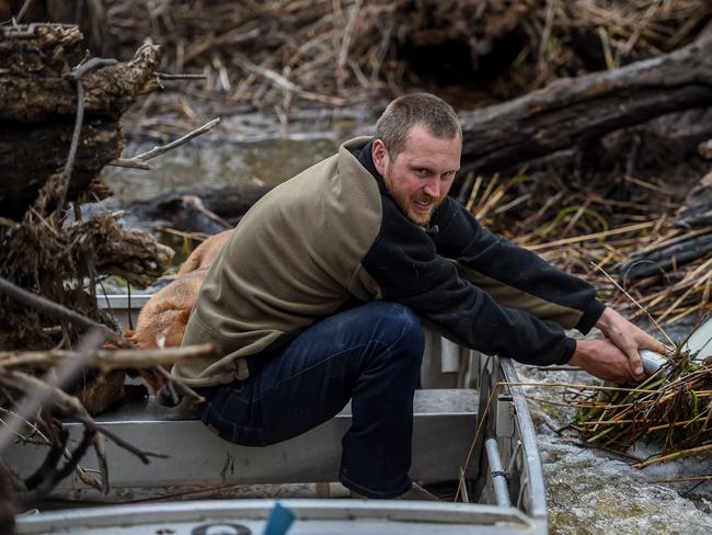 Mr Sewell grits his teeth as he fights to steaday the boat. Picture: Jake Nowakowski