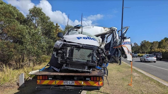 A police car is removed from the scene of the crash at Anzac Ave at Mango Hill.