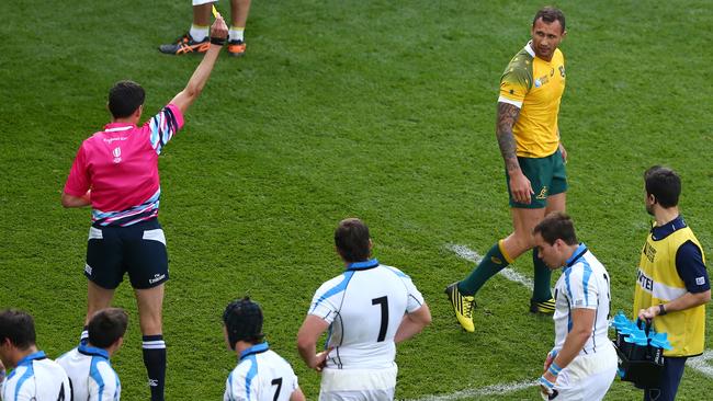 Cooper of Australia leaves the field after being shown yellow by referee Pascal Gauzere.