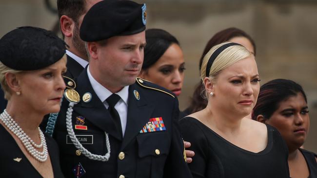 Cindy McCain, her son James McCain and daughter Meghan McCain hold back tears at the funeral of the late Senator John McCain. Photo: Getty Images