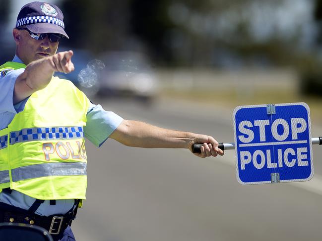 Members of Central Coast Highway Patrol conduct RBT on drivers, in the lead up to Christmas, at Wilfred Barrett Drive, North Entrance.