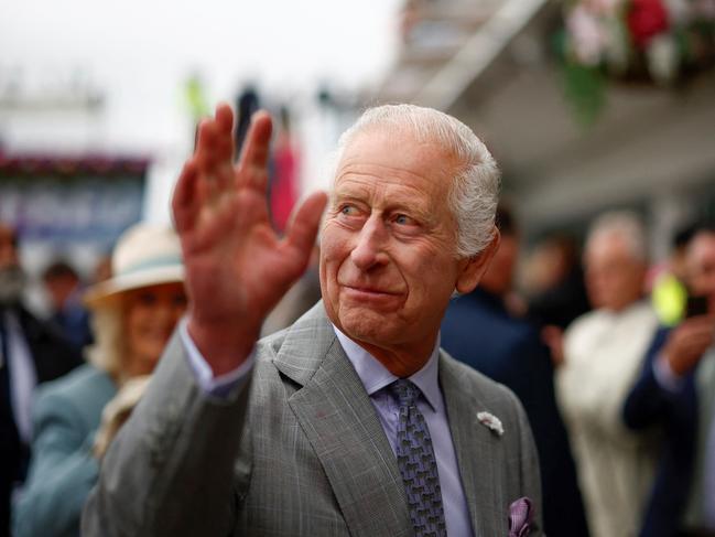 Britain's King Charles III waves to members of the public as he arrives to attend the first day of the Epsom Derby Festival horse racing event, in Surrey, southern England, on May 31, 2024. (Photo by BENJAMIN CREMEL / AFP)