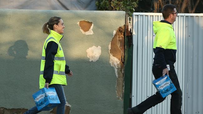 SA Water staff deliver boxes of water after a burst water main on Jeffcott St, North Adelaide. Picture: Tait Schmaal.