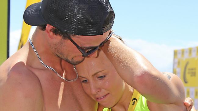 Georgia Miller embraced by boyfriend, Olympic kayaker Riley Fitzsimmons after winning the Coolangatta Gold. Photo: Harvpix