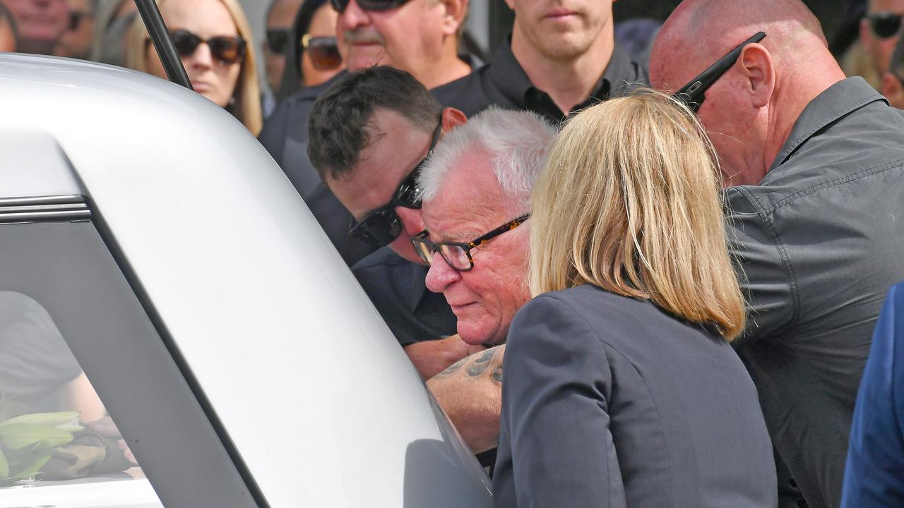 Mourners at Ash Jenkinson’s casket as it is placed in the funeral car. Picture: NCA NewsWire / John Gass