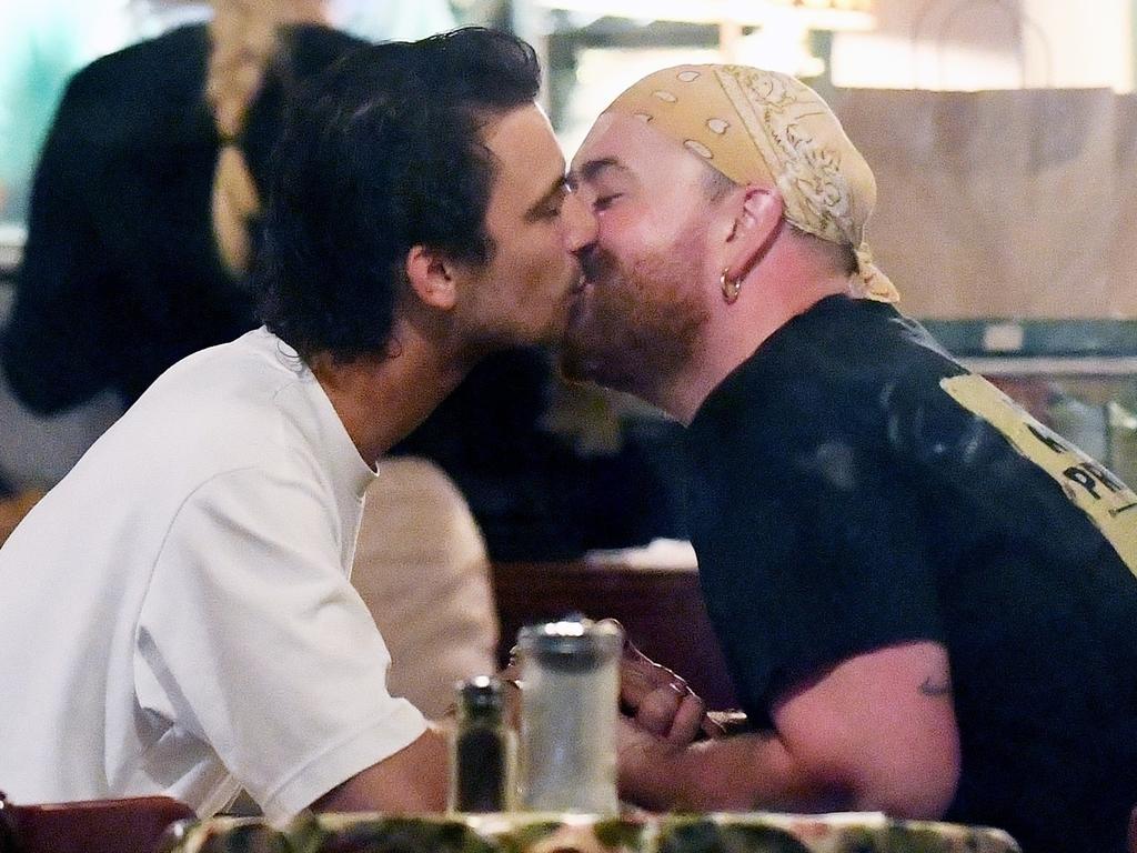 Sam Smith and boyfriend Christian Cowan share a passionate kiss during a dinner date at fish and chip restaurant A Salt Battery in New York City. Picture: Josiahw/Backgrid